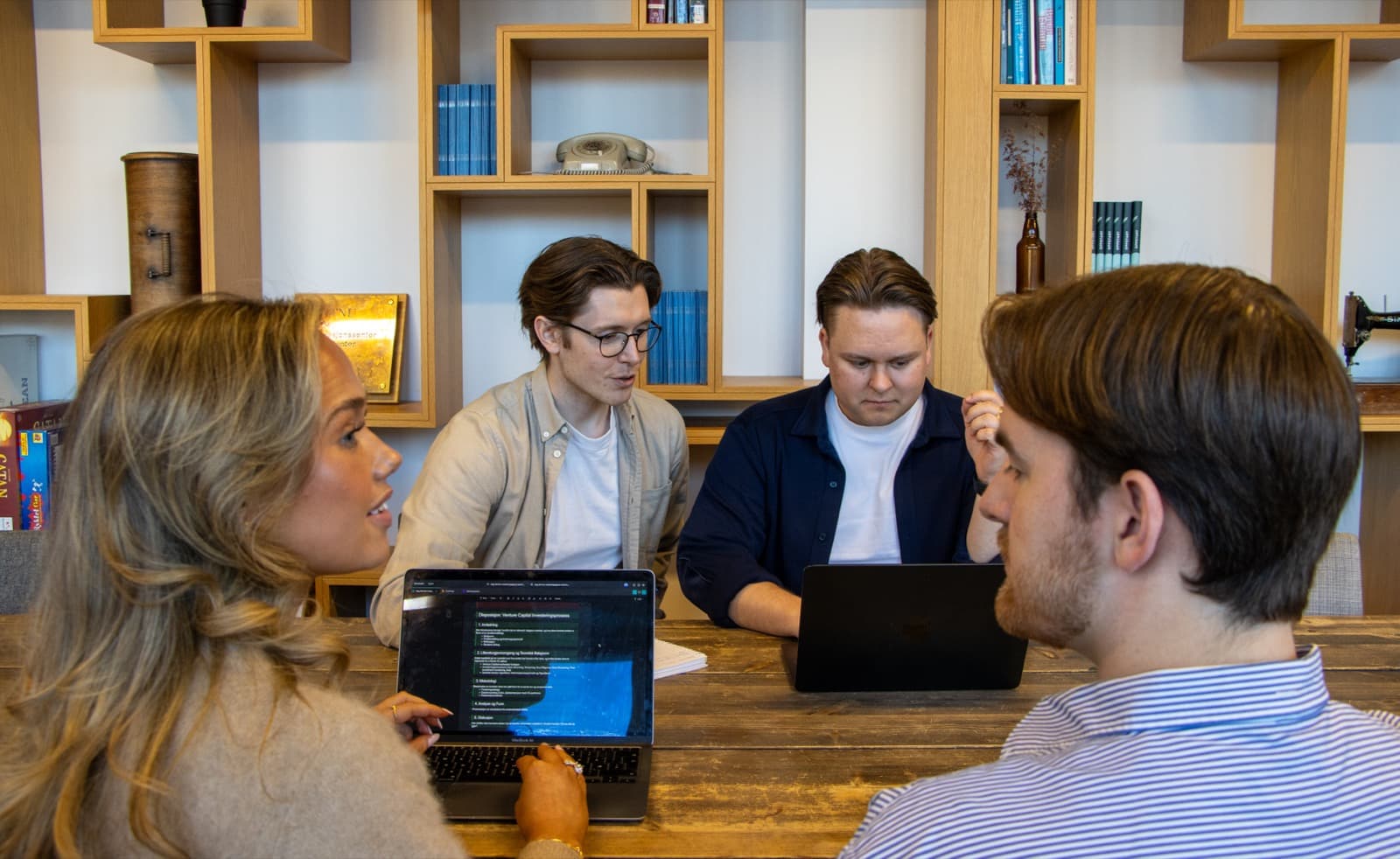 The Skriptr team working together around a table.